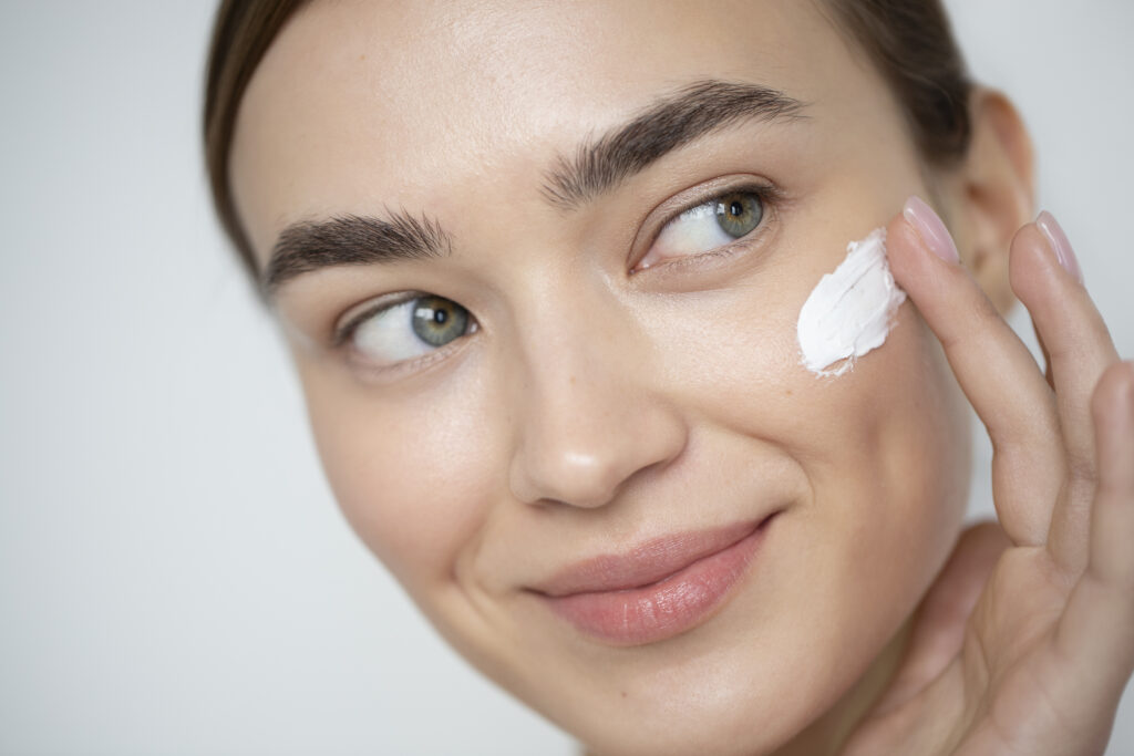portrait-beautiful-woman-with-clear-skin-using-moisturizer (1)