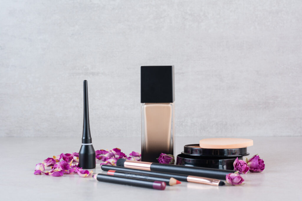 Close up photo of make up products on grey background