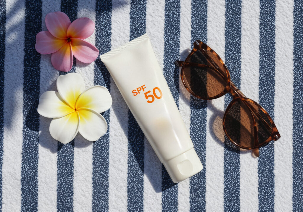 summer-essentials-sunscreen-sunglasses-flowers